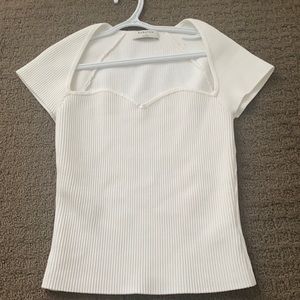 Aritzia, white shirt with a low cut. Size small. never worn + in good condition
